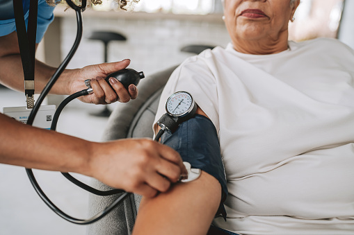 Doctor taking a woman's blood pressure.