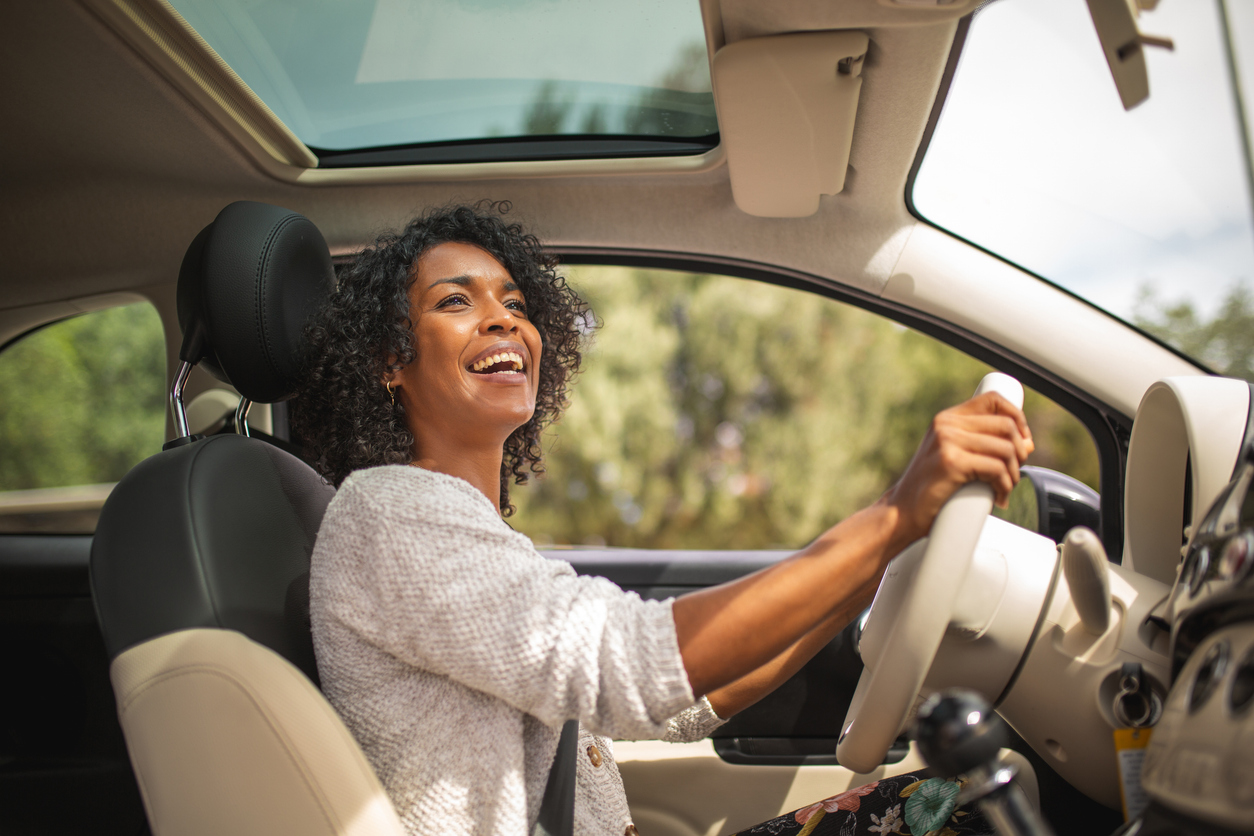 Smiling woman driving her car.