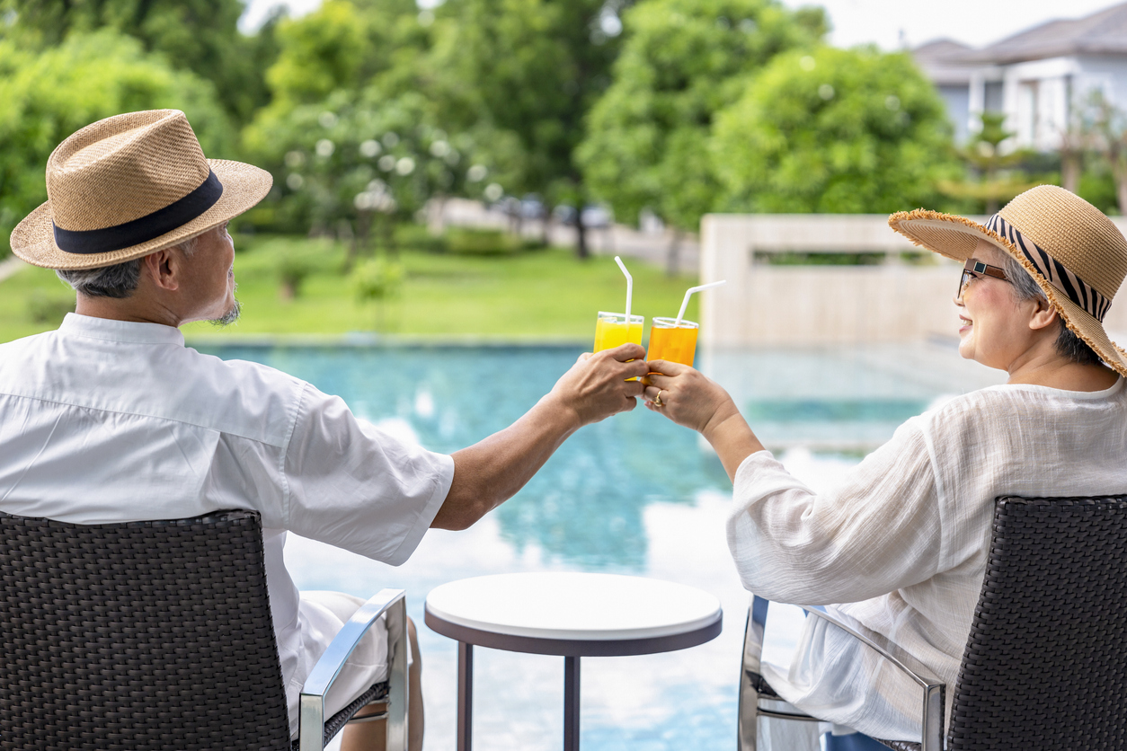 Senior couple relaxing by the pool.