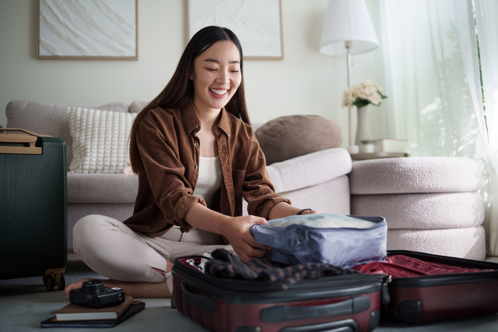 Woman packing her suitcase.